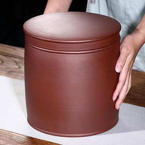 Heavy Hitter Ceramic Rice Jar Round With No Sweat Seal, retro brown storage for grains held by a person on a wooden table.