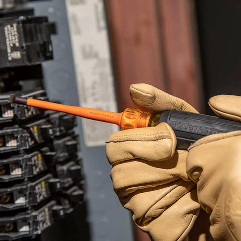 Worker uses Pro Grade 1000V Insulated Screwdriver Set with Pliers and Wire Stripper for safe electrical panel work.