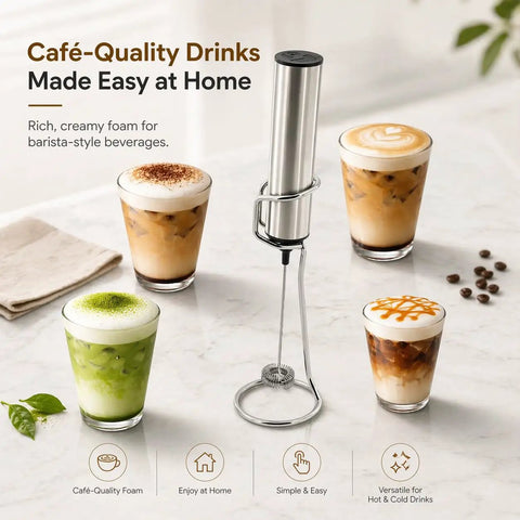 Rechargeable Milk Frother With Stand Electric Whisk Foam Maker USB C Two Speed Handheld Drink Mixer For Coffee Latte Cappuccino Matcha Drinks Silver Finish on a table with four foam-topped beverages