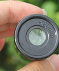 Close-up view of 20mm Telescope Eyepiece 0.965 Inch Diameter Fully Multi Coated Optical Glass Metal Housing in hand.