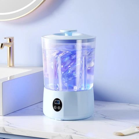 Hassle Free Cordless Mini Washing Machine With Rechargeable Battery And Three Wash Modes For Underwear Socks And Daily Threads Compact Dorm And Camp Ready Laundry Rig on countertop with blue light.