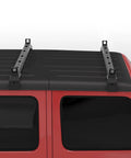 Heavy Duty Black Roof Rack Crossbars For Jeep Wrangler JK JL Gladiator JT Hardtops mounted on a red vehicle roof.