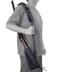 Person holding a rifle with a Rifle Buttstock Cover With Leather And Waxed Canvas Cushion, Matching Gun Sling, in black, side view.