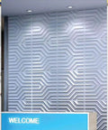 Geometric 3D PVC Wall Panels Matte White Pack of 12 Tiles Covering 32 Sq Ft, Each 19.7 Inch Square installed in office wall