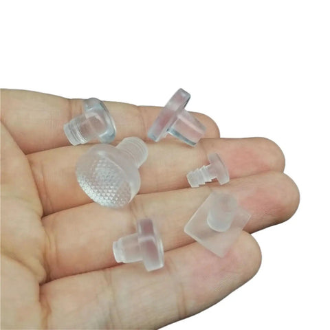 Hand holding Leveling Feet Kit For Furniture 96 Pieces Soft Clear Rubber Embedded Adjustable Wobble Free Leg Pads