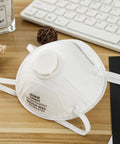 N95 Face Mask With Breathing Valve Pack Of 15 For Adults NIOSH Certified Cup Style Particulate Mask White Disposable Masks For Men And Women Great For Everyday Use At Work Or Travel Safe And Comfortable All Day displayed on wooden desk