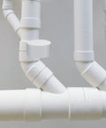 Two Inch Schedule 40 PVC Vent Cap With Mesh Screen And Stainless Steel Termination Cap on white piping system