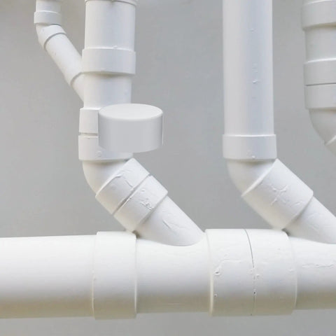 Two Inch Schedule 40 PVC Vent Cap With Mesh Screen And Stainless Steel Termination Cap on white piping system