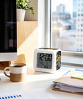 Solid Build Cube Digital Alarm Clock With Seven Color Led Night Light And Easy Peasy Snooze tracks time, date, temp on desk.