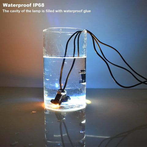 Universal Amber LED Front Grille Marker Lights with Projector Lens submerged in water showcasing IP68 waterproof feature.