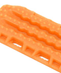 Close-up of orange Sand Ladder For RC Cars Off Road Recovery Ramps 2 Pack Plastic RC Recovery Tool with textured surface.