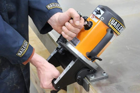 Close-up of Heavy Duty Portable Beveling Machine With 1 HP Brushless Motor 110 Volt Power in use on metal surface.