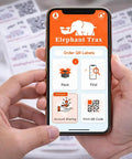 Person using app on smartphone to manage Smart QR Code Labels For Storage Bins And Moving Boxes 40 Pack Scannable Stickers For Totes.