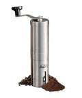 Manual Stainless Steel Coffee Grinder With 18 Adjustable Settings, Portable Conical Burr, surrounded by ground coffee and beans.