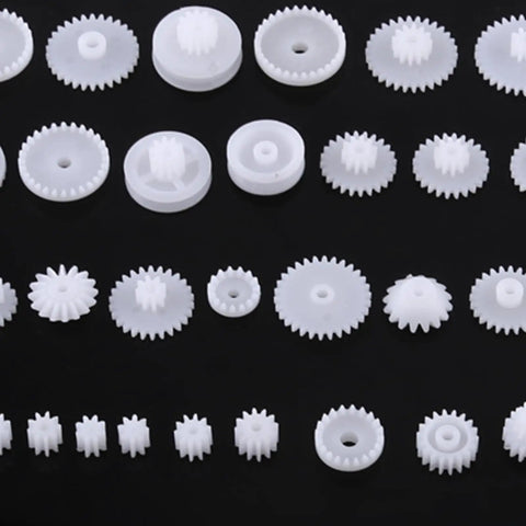 Grab This Awesome DIY Robot Gears And Pulley Belt Kit With 64 Kinds Of Wearable Plastic Parts Perfect For Tech Models, Car Robots, And Cool Motor Projects You Can Build Your Own Stuff With Today. White plastic gears set on black background