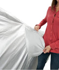 Woman holding Heavy Duty All Weather Car Cover Gonna Shield Your Tesla Model S Like Armor, showcasing breathable silver material.