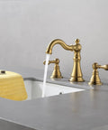 Two Handle Brushed Gold Bathroom Faucet For 3 Hole 8 Inch Widespread Lavatory With High Arc Spout And Pop Up Drain Lead Free And CUPC NSF Certified Easy Install Solid Brass Construction Fits 8 To 12 Inch Spread Lavatory Model F 8805 BG installed on sink