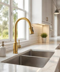 Gold Brushed Nickel Kitchen Faucet with Pull Down Sprayer, 3 Mode Sprayer above stainless steel sink in modern kitchen.