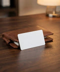 Heavy Duty 50 Piece Set Blank White Pvc Id Cards Dual Sided Printable With Smart Chip Access resting on a brown wallet.