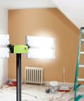Room with bright LED lights on stand, ladder, and painting supplies in background