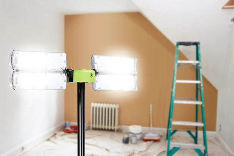 Room with bright LED lights on stand, ladder, and painting supplies in background