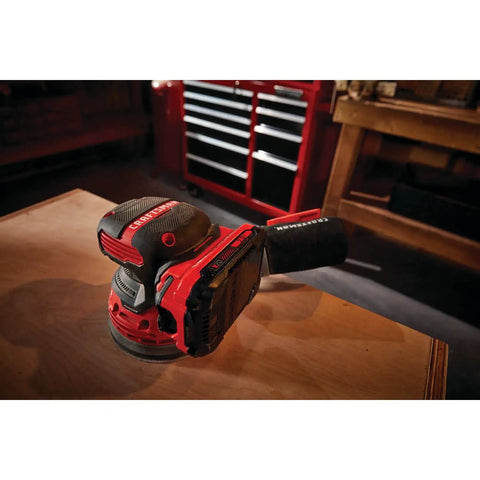 V20 Cordless 5 Inch Orbital Sander Bare Tool with 12,000 OPM on a workbench, showing lightweight low profile and dust bag