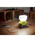 18V ONE Plus EverCharge LED Area Light with 1.3 Ah battery, lit on a workbench, showcasing wall mount charger and cordless design