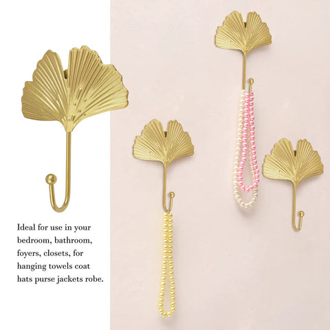 Ginkgo Leaf Wall Hooks Four Piece Iron Gold Key Holder And Hat Hanger, displayed with necklaces on neutral wall