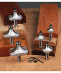 Top Shelf Six Piece Roundover And Beading Router Bit Set With Razor Sharp Carbide Blades Built Hardcore For Handheld Or Table Mounted Woodworking Rigs Ready To Roll on wooden bases with tools.