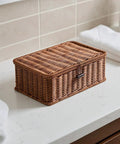 Three Piece Rectangular Woven Storage Bins With Lids Feature Slick Plastic Rattan Construction To Keep Your Home Tidy And Knocking Out Daily Clutter With Zero Hassle Prime Pick For Any Home Or Office, placed on a bathroom counter.