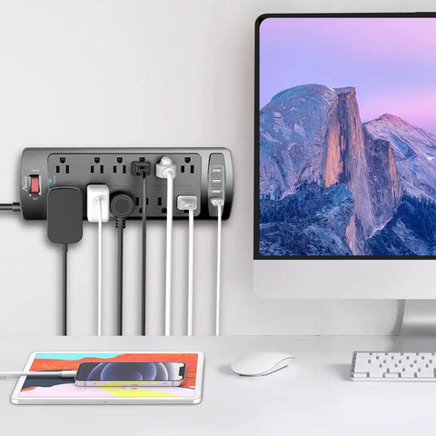 Six Foot Surge Protector Power Strip With Twelve Outlets And Four USB Ports, Heavy Duty Extension Cord, 2700 Joules, Overload Protection, Perfect For Home Office, Gaming Setup, And More. on desk with multiple devices plugged in