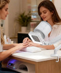 Professional Nail Dust Collector Dishing Out Killer Suction For Talk Friendly Salon Or Home Manicure And Pedicure Sessions Featuring 360 Degree Adjustable Arm Honeycomb Intake For Smooth Gel Acrylic Cleanup in use during a manicure.