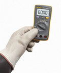 AC And DC Current Handheld Digital Multimeter With Backlit Display Pro Grade Tool for Quick Voltage and Current Readouts in gloved hand