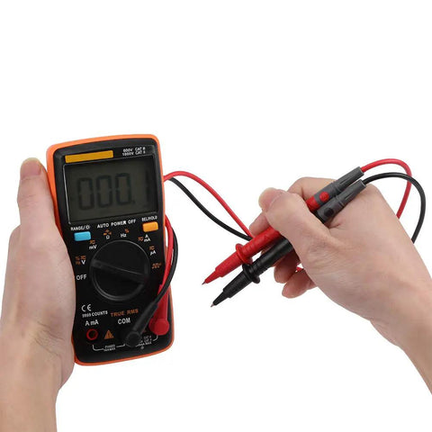 True RMS Digital Multimeter Go-To Tool For AC DC Voltage And Current, Handy Ohms Meter With Auto Range in use, hands holding probes