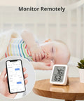 Pan Tilt 2K Indoor Camera With Thermometer Hygrometer And Hub Mini All In One Smart Home Surveillance Kit showing climate data near sleeping baby