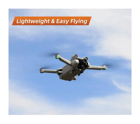 Drone in flight against a blue sky, showcasing Premium Carbon Fiber Propeller Blades Compatible with Mini 3 Pro and Mini 4 Pro Genuine 6030F Rotors Include Screwdriver Kit.