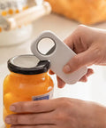 Using 3 In 1 Magnetic Bottle Opener And Can Opener White Stainless Steel Manual Kitchen Tool on a jar lid