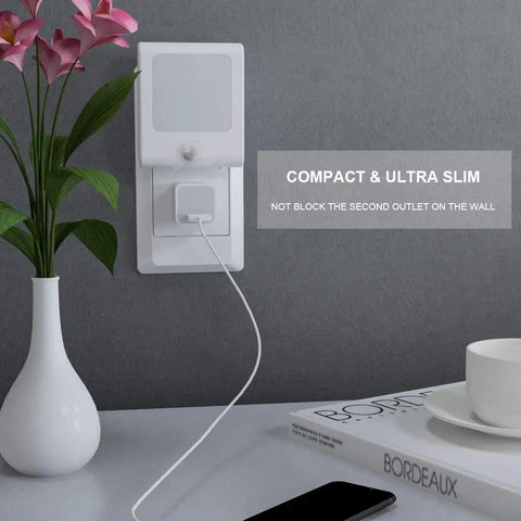 Compact plug in motion sensor night lights with adjustable brightness from 0 to 25 lumens 2700K warm white in living room wall outlet.