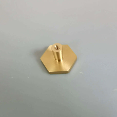 Top Tier Solid Brushed Brass Hexagon Knobs 6 Pack For Kitchen Cabinets And Drawers With Mounting Hardware 1.2 Inch hexagon knob close up.