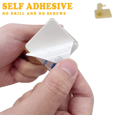 Gold Heavy Duty Self Adhesive Hooks 4 Pack Wall Mounted For Towel Key Coat Hat Robe Clothes Waterproof Aluminum No Drilling Required Ideal For Bathroom And Kitchen showing adhesive backing detail.
