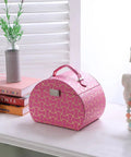 Eight Point Eight Inch Hot Pink Travel Jewelry Organizer Case With Built In Mirror And Snug Pockets on a dresser beside decor.