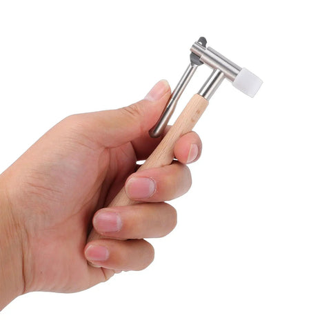 Hand holding Watch Movement Pinion Puller Pro Grade Repair Tool with wood handle and stainless steel tip