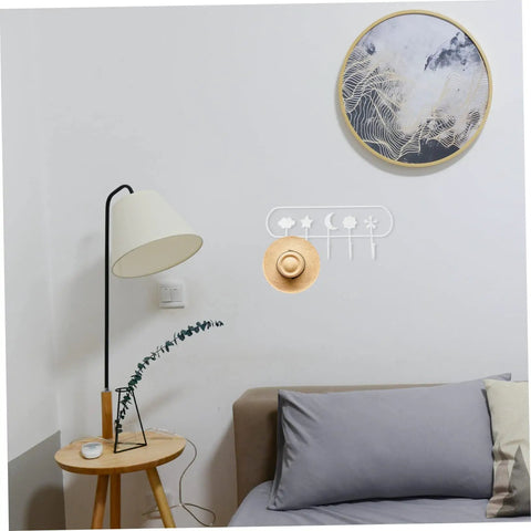 Heavy Duty Adhesive Hook Set That Stays Rock Solid No Sweat Install for Hanging Towels Coats Bags Keys with gray sofa and lamp.