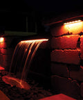 LED Color Changing Hardscape Light 6-Inch Multicolored With Oil Rubbed Bronze Finish illuminating outdoor waterfall