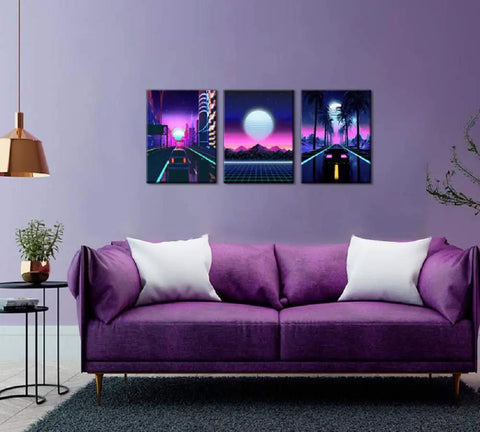 Neon Cyberpunk City Wall Art Set, 3 Panels, 12x16 Inches, Teen Boy Room Decor, Cars Driving Through Neon Suburbs, Retro 80s Inspired Landscape Canvas For Bedroom, Living Room, Or Office displayed above a purple sofa in a modern room.