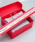 Mini Self Adhesive Folding Piano Hinge For Boxes And Cabinets Clear Transparent Hinge on a red cardboard box