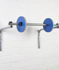 Slick Wall Mount Bubble Wrap Dispenser With Heavy Duty Galvanized Steel holding bubble wrap rolls against a white wall.