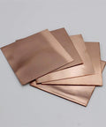 Stack of single sided copper clad laminate kit packed with 10 prototyping boards 7 by 10 cm for DIY PCB etching 0.06 inch thick.