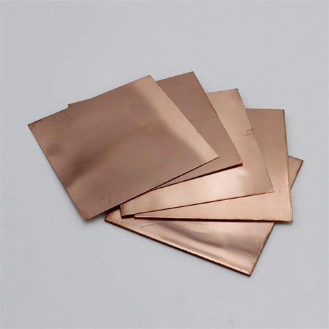 Stack of single sided copper clad laminate kit packed with 10 prototyping boards 7 by 10 cm for DIY PCB etching 0.06 inch thick.