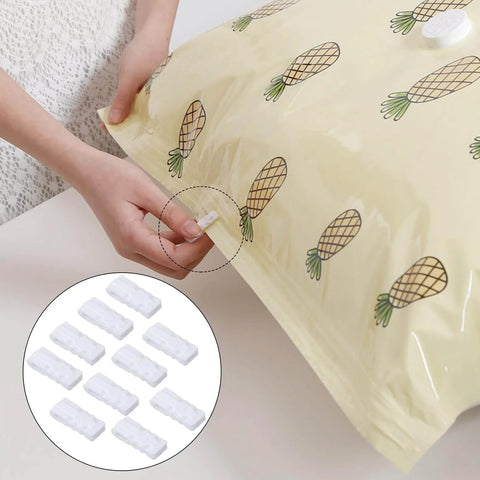 Hands using Ten Pack Vacuum Storage Bags Sealing Clips Set With Reusable Zipper Grips, compressing pineapple-printed bag for storage.
